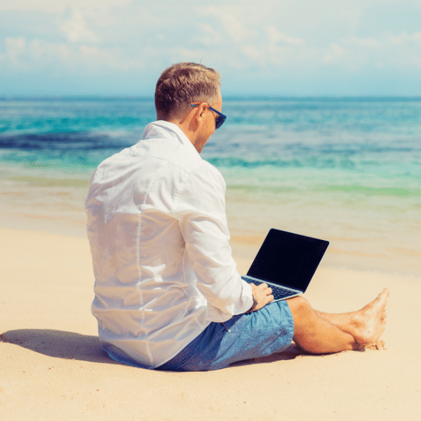 working from a laptop computer on the beach
