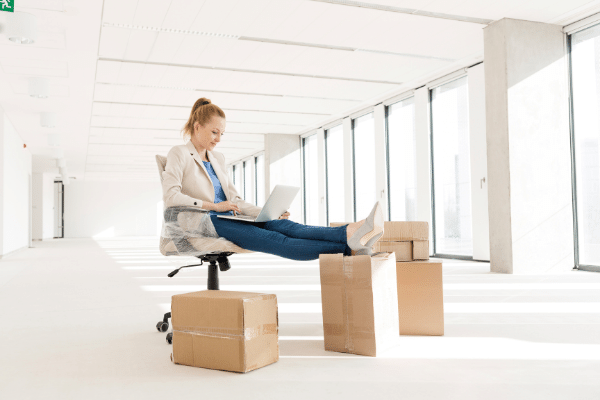 what is the best business to start now? Woman sat on boxes in a new office starting a new business
